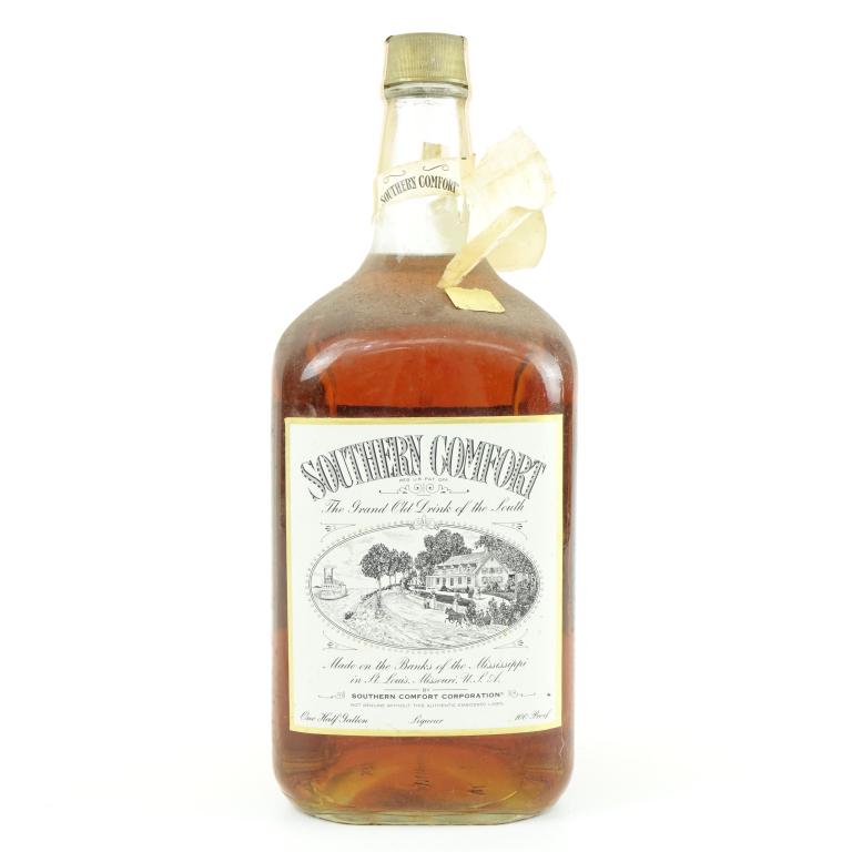 1974 (?) Southern Comfort Bottle: *** IF YOU MAY NEED SHIPPING YOU MUST SPEAK WITH IAN BEFORE BIDDING ON BOTTLES 847-625-0555 *** 1974 (?) Southern Comfort Bottle: 100 proof, 1/2 gallon, and sealed. Neck label is torn!
