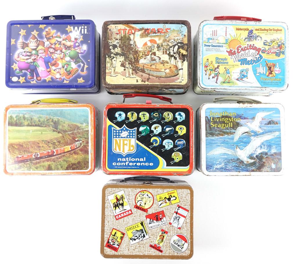 7 Lunch Boxes - Vintage: 1977 Star Wars (missing handle and thermos). NFL football (with thermos), Jonathon Livingston Seagull. Metric System with thermos. CN rail. World Travel. Wii.