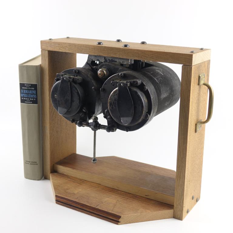 WWII U.S. Navy Submarine Binoculars: Plaque marked "BU. ORD. USN Mark 91." By Bausch & Lomb. With eye cups, flip-up lens caps mounted on a newer wooden stand. Includes a book on WWII submarine operations. These binoculars were known as "