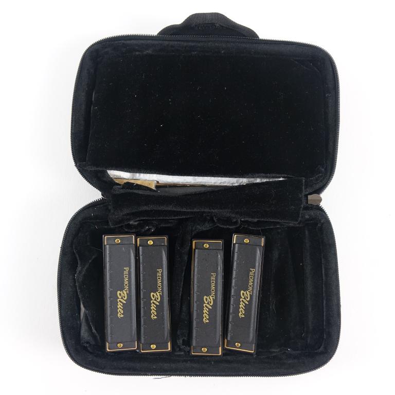 Piedmont Blues Harmonicas (4): - 4 pieces. - Includes a case. Stop stalking John Popper!