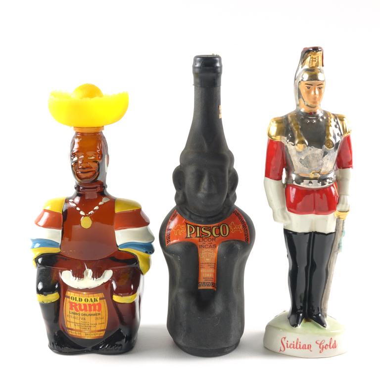 Liquor Figural Decanters (3): **IF YOU MAY NEED SHIPPING PLEASE CALL US AND SPEAK WITH IAN BEFORE BIDDING ON BOTTLES. 847-625-0555.** Pisco Licor de los Incas. Old Oak Rum: 43%, 757ml and is full / sealed. Sicilian Gold: 20%, 8.0z