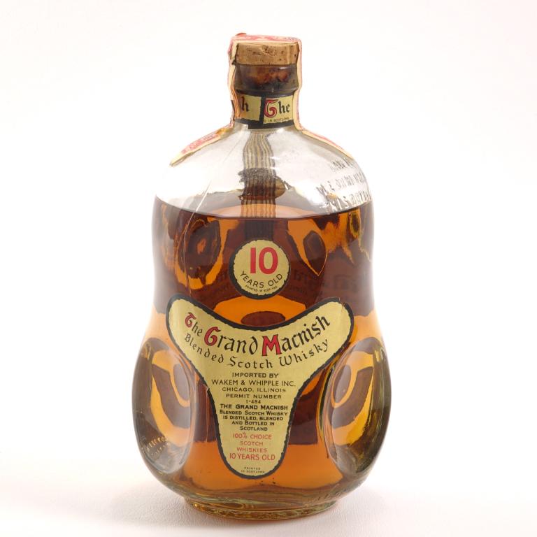 Grand MacNish Blended Scotch: ** IF YOU MAY NEED SHIPPING, PLEASE CALL US BEFORE BIDDING ON BOTTLES. 847-625-0555. ** 88 proof, 4/5 qt and sealed. 10 years old. Low shoulder fill. Wire and portion of label missing. With Illinois S