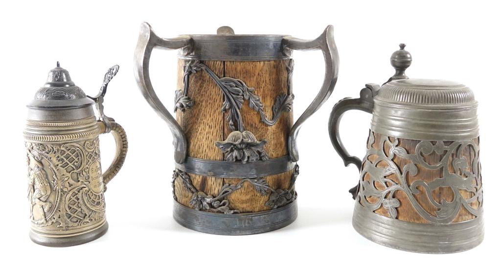 Beer Steins (3): Three handle oak and metal; 9.5" tall. Lidded wood and metal stein 6.5" tall. Lidded, Western Germany, original mold 1984.