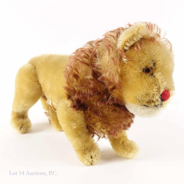 Steiff Lion (1940s/50s?): Steiff Lion. Tag says "Made in US Zone Germany". Legs articulate. Metal Steiff button in left ear. 7-1/8" tall (standing on all 4 legs) and 12" long, nose to tail.
