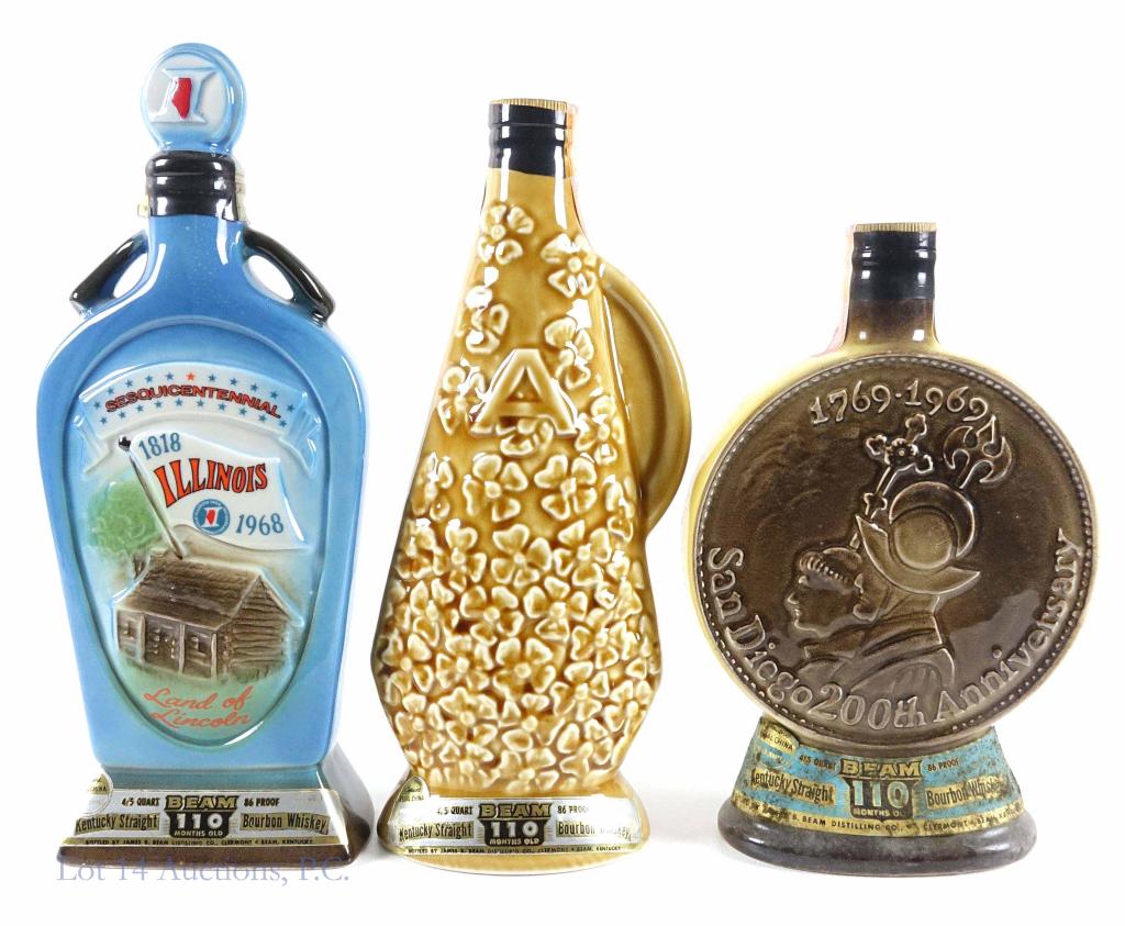 Older Beam's Whiskey Decanters (3): *** IF YOU MAY NEED SHIPPING, YOU MUST SPEAK WITH IAN BEFORE BIDDING ON BOTTLES*** 3 Beam's Bourbon Whiskey decanters: San Diego, Illinois, and "A". 86 proof. 4/5 quart. 110 months. Full (or nearly fu