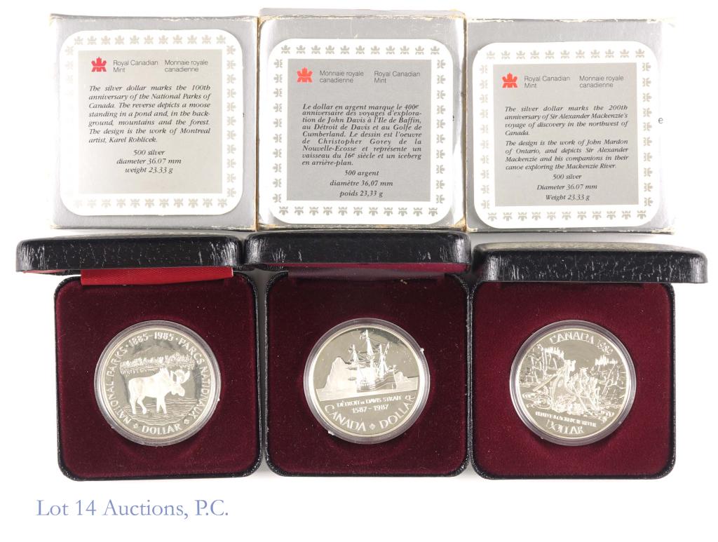 Canadian Proof Silver Dollars (3): 3 proof Canadian silver dollars - all coins 0.5 silver in original RCM boxes with COAs: 1985 (National Parks), 1987 (Davis Strait - box and sleeve in rougher condition), 1989 (Mackenzie).