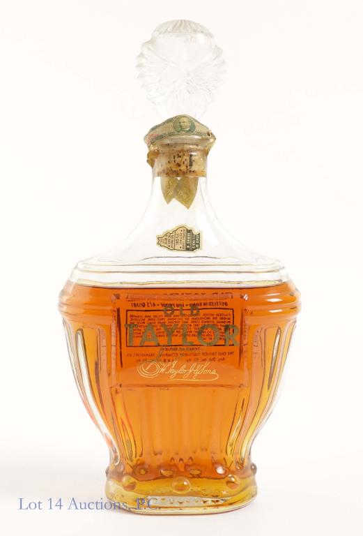 1953 Old Taylor Bourbon- BIB: *** IF YOU MAY NEED SHIPPING, PLEASE CALL US BEFORE BIDDING ON BOTTLES! 847-625-0555. *** 100 proof, 4/5 qt and sealed. Shoulder fill.