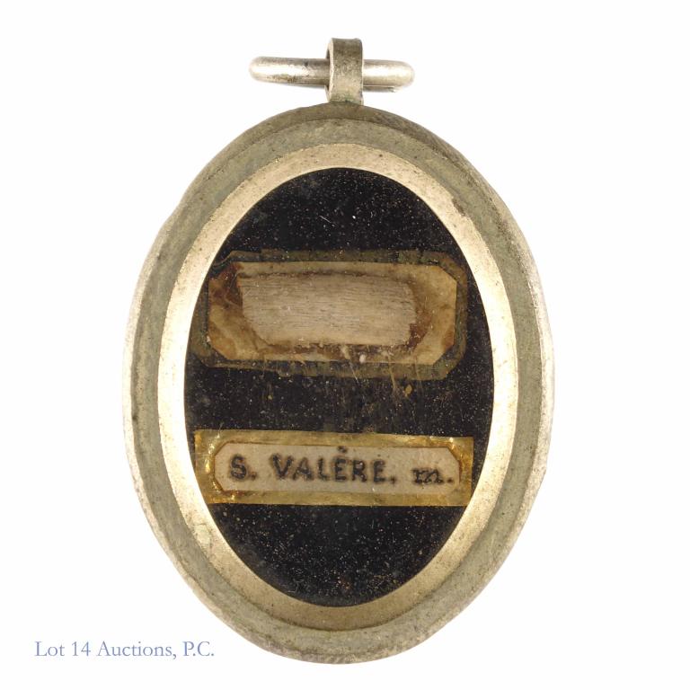 Saint Valerie of Milan Reliquary with Catholic Relic: Saint Valerie of Milan reliquary. white metal theca with wax seal and threads intact. Saint Valerie was the wife of a saint and the mother of two others. She is the protector of those in storms and fl