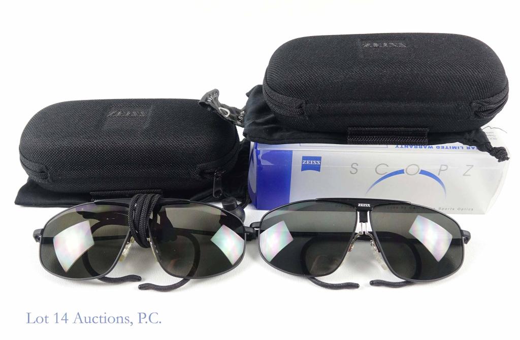 Zeiss Sunglasses (2): Zeiss CE Scopz sunglasses Mod. 7920-100 64-9 165 (2x). Both in case with dust bag. Appear to be in good condition. One has a strap and the other does not.