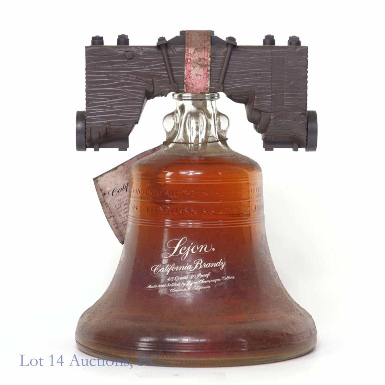Lejon California Brandy in Liberty Bell: **IF YOU NEED SHIPPING ON BOTTLES OR DECANTERS PLEASE CALL US BEFORE BIDDING! 847-625-0555!** Basement pick with vintage dirt. 80 proof, 4/5 qt and sealed. With neck tag. Came out of a very old and es