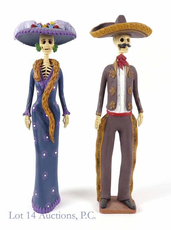 Ramon T. Dia de los Muertos / Day of the Dead (2): 2 Sculptures - Catrina Y Catrine. A pair of Day of the Dead statues. They appear to be made of fired clay, and their heads swivel. The senora is 17-1/2" tall, and the caballero is 18" tall. Both statu