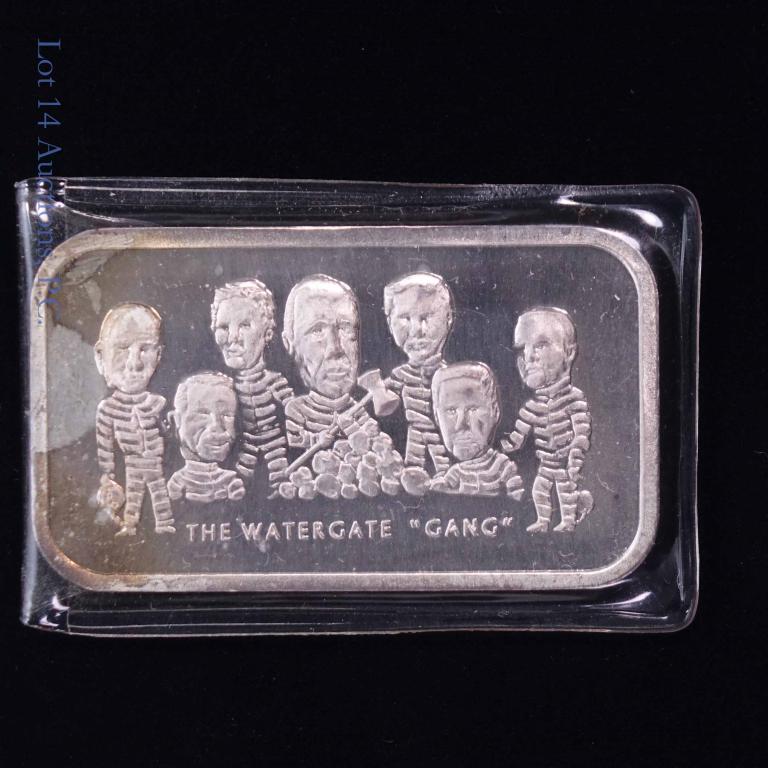 "The Watergate Gang" 1 ozt Silver Bar: Colonial Mint 1 troy ounce bar of 0.999 fine silver depicting Richard Nixon's "Watergate Gang" in prison uniforms. We believe this was minted and released in 1973. In original plastic envelope. A grea