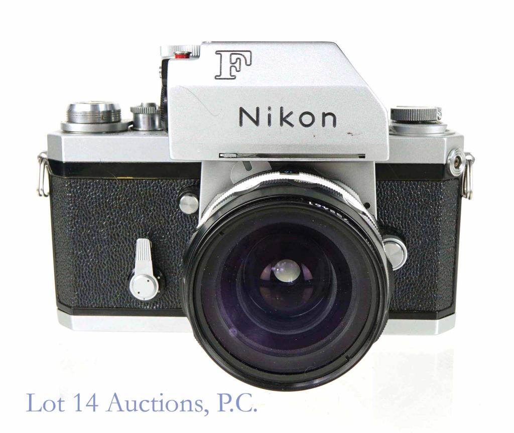 Nikon F Photomic T 35mm SLR Camera & 28mm Lens: Circa 1970 Nikon 35mm Model F camera with Photomic T (S/N 6766214). Appears to function correctly, but untested and not serviced. Clean battery compartment. Some paint loss to hinge for film door. Nik