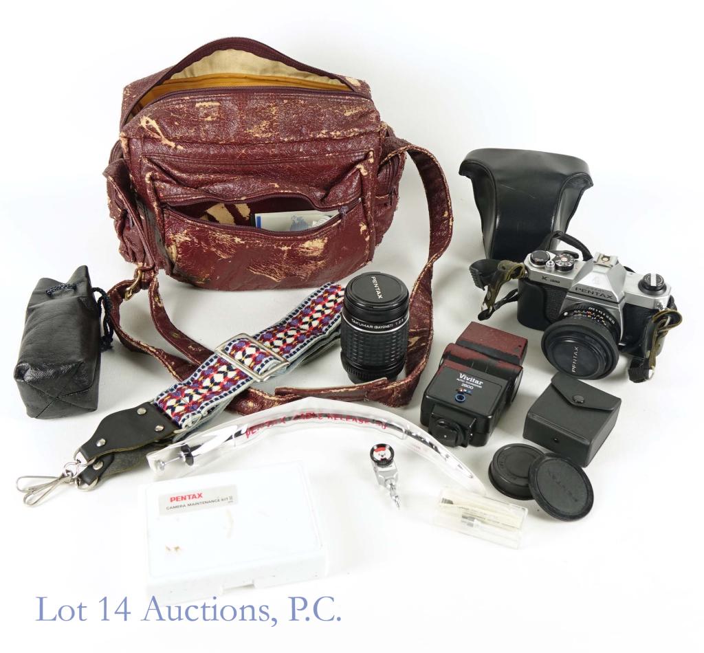 Pantax Asahi K1000 Camera + Lens: 1980s camera in case with 50mm lens attached. Includes a Takumar (Bayonet) 1:2.5 135mm. lens, a self timer mechanism, a cleaning kit, an extra woven strap, and a carrying case (faux leather peeling). 