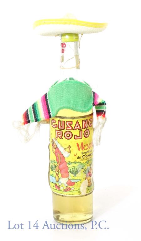Gusano Rojo Mezcal from Oaxaca (With Worm): *** IF YOU MAY NEED SHIPPING, PLEASE CALL US BEFORE BIDDING ON BOTTLES! 847-625-0555. *** Gusano Rojo Mezcal. Oaxaca, Mexico. Worm inside bottle. Comes with tiny sombrero and poncho. Label has damage,