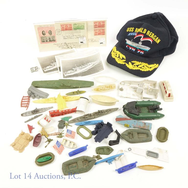 Navy Hat Postcard Stamp and Toy Collection: Ronald Reagan CVN 76 Navy Blue snap back hat. Plastic ship and boat toy collection. Longest being about 7" long. (3) U.S. Naval Ship photo postcards. (2) First Day Cover mail envelopes dated January 1