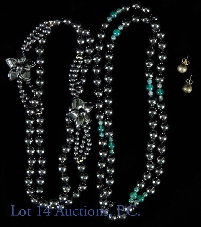 Hematite Bead Necklaces: Two hamatite beaded necklaces. One features a couple of flowers of the same material, measures 28". The other has (possibly) jade beads breaking up the pattern and measures 30". The lot also comes wit