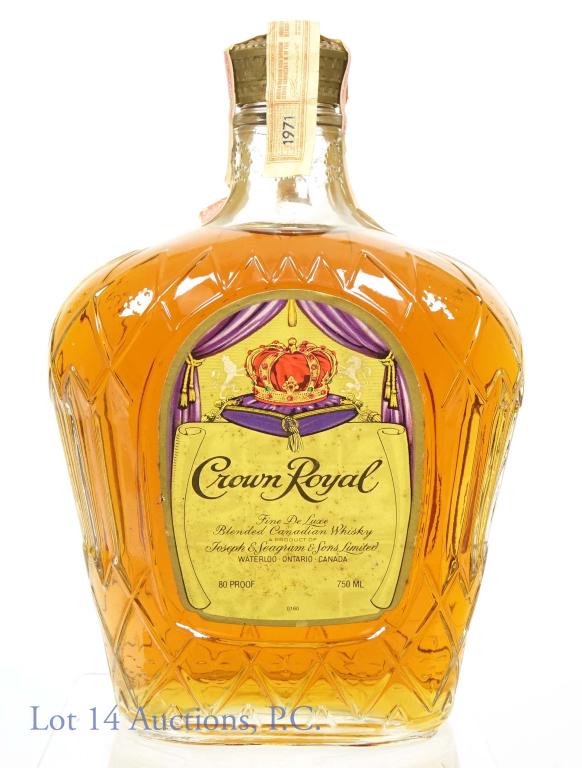 1971 Crown Royal Canadian Whisky: Crown Royal blended Canadian whisky. 80 proof, 750 ml. Full and sealed. Date strip is loose but still attached to tax strip. Some stains on label.