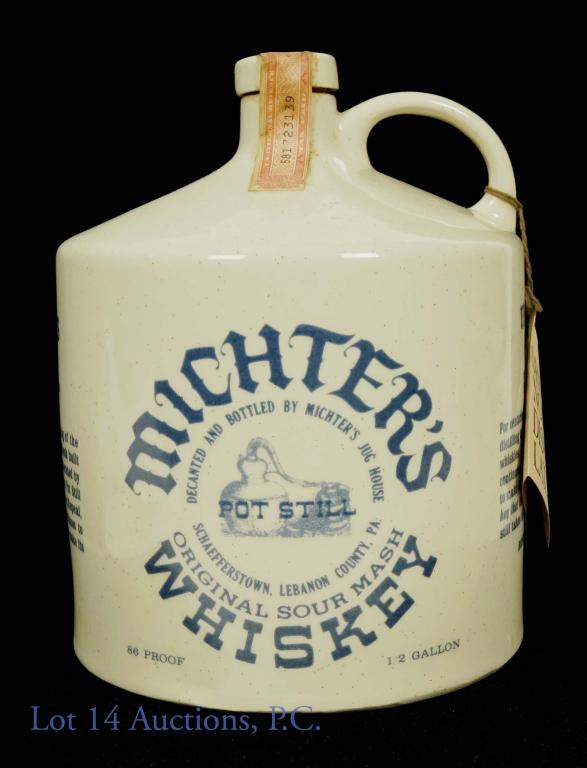 1976 Michters Sour Mash Whiskey (1/2 Gallon): Michter's original pot still sour mash whiskey. 86 proof. 1/2 gallon. Pennsylvania Dutch jug. Handle tag present. Series 112 (Internal Revenue) tax strip (1960 - 1977). Marked as Series B 1976. 5.1 po