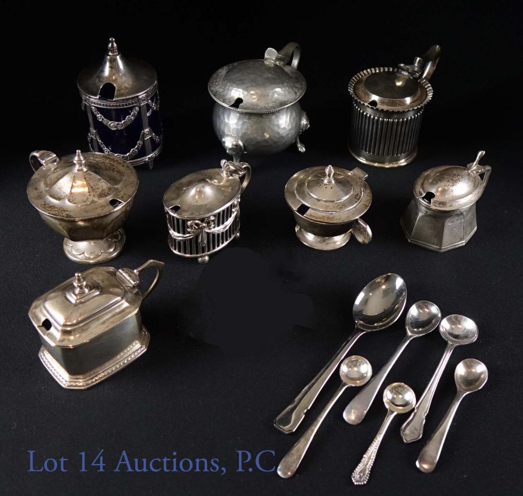 Sterling Silver & Plated Cobalt Salt Cellars (8): Eight silver plated salt cellars, seven with cobalt glass liners, and one with blue porcelain and six silver plated and stainless steel spoons. (To the best of our ability, we decoded the hallmarks, b