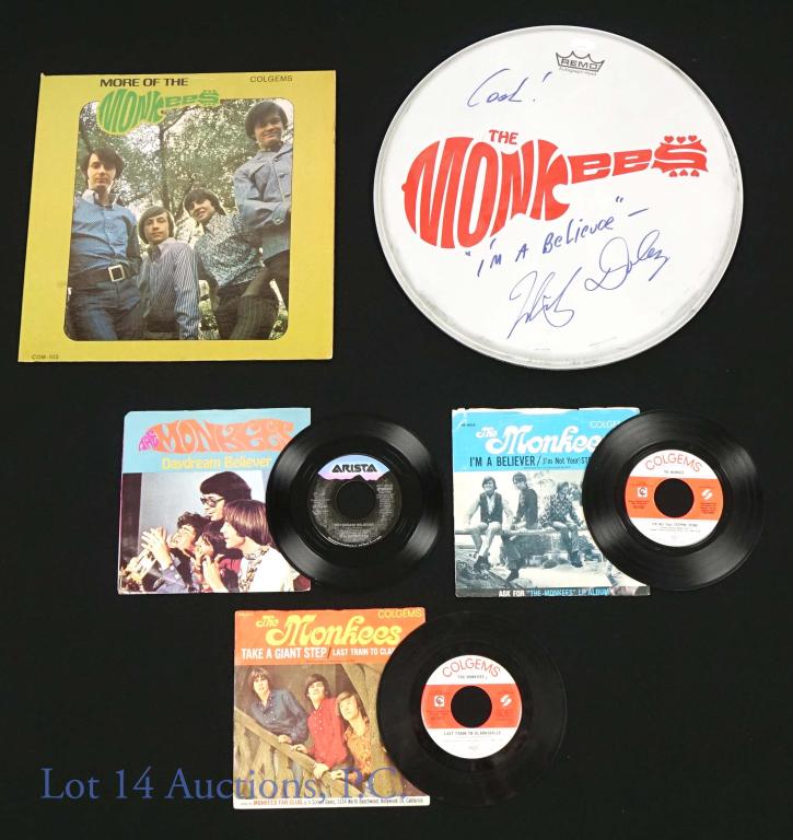 Monkees Micky Dolenz Signed Drum Head and Records: The Monkees Micky Dolenz autographed drum head made approximately 14.5" diameter. JSA sticker on top and Cert Number: AI9216. Inscription is "Cool! I'm a believer". Condition note: few scraps around e