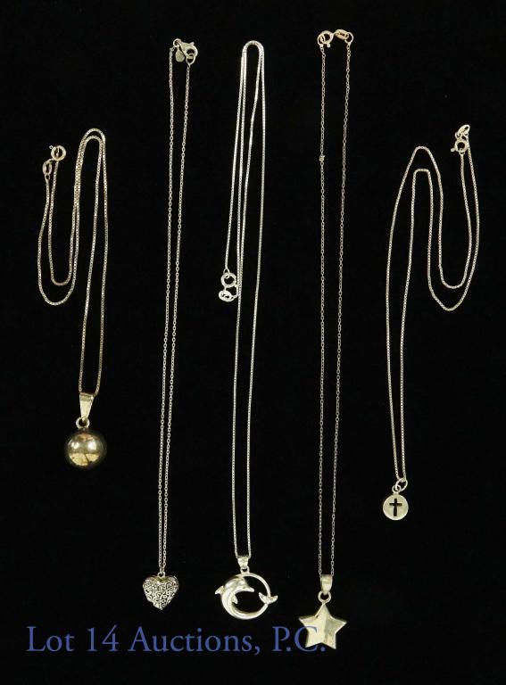Sterling Silver Necklaces (5): 5 sterling silver necklaces, all marked 925. Each has a unique pendant: dolphin, heart locket, star, sphere, and cross. Chain lengths: 16-23". Total weight 23.9g