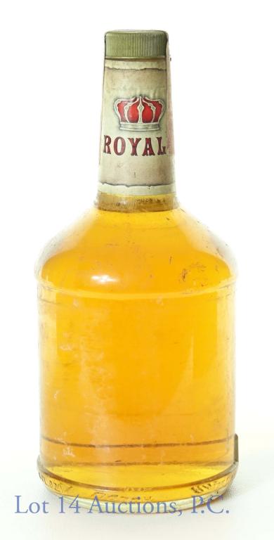 1981 Mystery Bottle of Whisk(e)y? Bourbon?: A mystery bottle of brown spirits. The neck strip has the word "ROYAL" below a red crown. 750 ml (25.4 fluid ounces). Series 112 (ATF) tax strip (1977 - 1982). The bottom of the bottle has an "81" emb