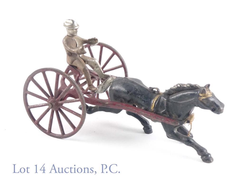 Cast Iron Horse Driver and Sulky (?): Cast iron horse, driver, and sulky. The nut holding the driver to the sulky is missing, as well as the reigns for the horse. We also cannot be sure that the entirety of the sulky / coach is present. 8