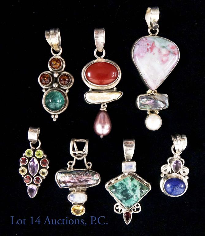 Sterling Silver and Gemstone Pendants (7) Lapis +: 7 sterling silver and multi-gemstone pendants. All marked 925. Stones include: lapis, apatite, jasper and more. Pendants measure from 1-2 inches. Total weight: 64 grams.