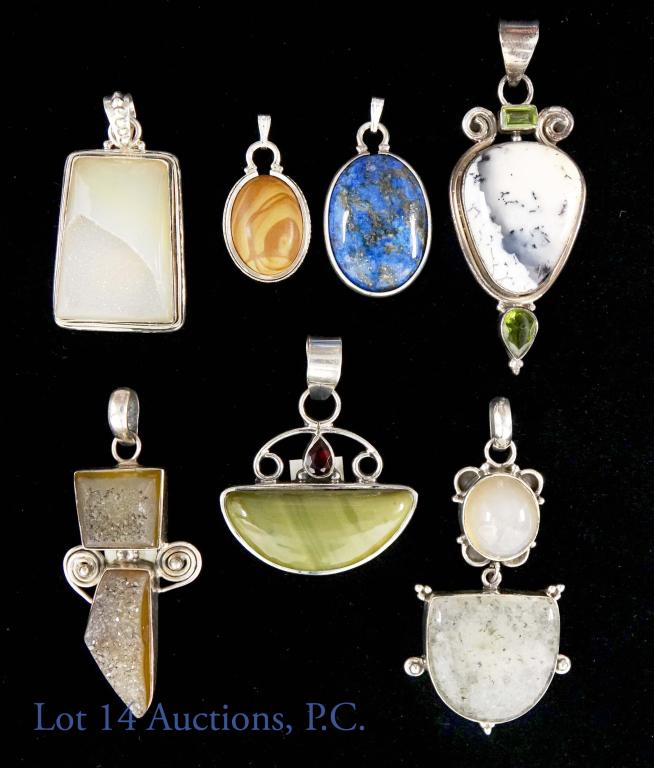 Sterling Silver and Stone Pendants (7) Opal +: 7 sterling silver and gemstone pendants. All marked 925. Stones include: opal, moonstone, and sodalite. Pendants measure from 3/4-2 inches. Total weight: 74 grams. *The rhombus-shaped, white stone is