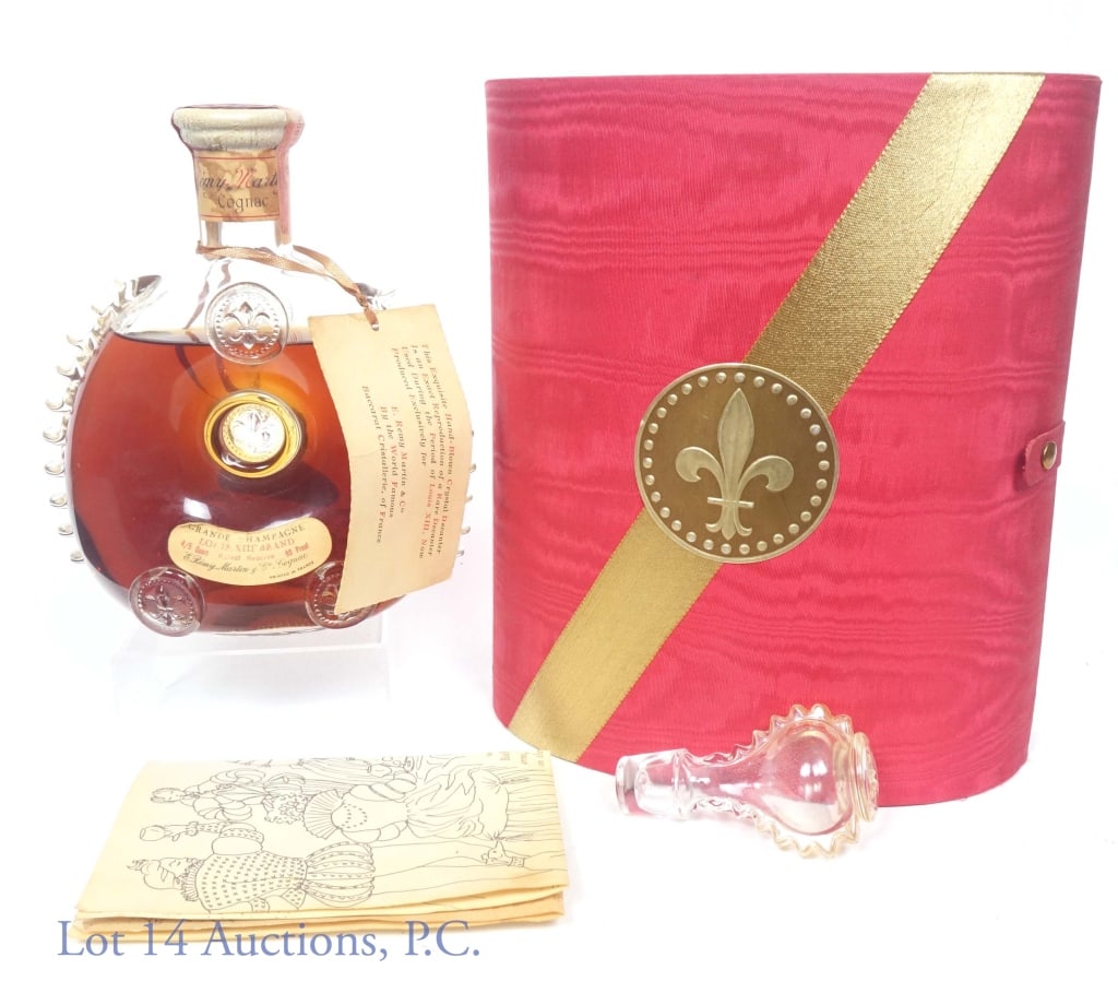 1960s Louis XIII Remy Martin Cognac in Baccarat: 1964-1968 Louis XIII Baccarat decanter Remy Martin Grande Champagne Rarest Reserve Cognac. 80 proof, 4/5 quart. White top Baccarat Crystal decanter in original red oval-split box, with stopper, neck t