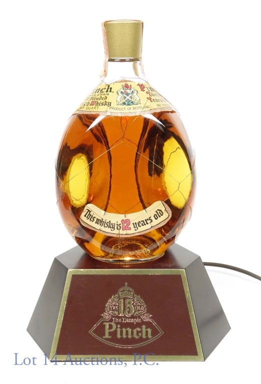 Haig & Haig Pinch Whiskey & Light Stand: Haig & Haig Pinch old blended Scotch whisky. 12 years. 86 proof. 4/5 quart. Series 112 (Internal Revenue) tax strip (1960 - 1977). This lot also includes a series 112 lighted stand for 15 year The Dim