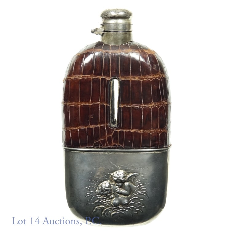 Sterling Silver Mounted Flask: Sterling silver mounted flask. Cup is sterling silver (marked) with cherubs and leather surrounding glass body. Circa 1920. 0.62 pounds (280 grams). Approximately 6" (15.2 cm) long.
