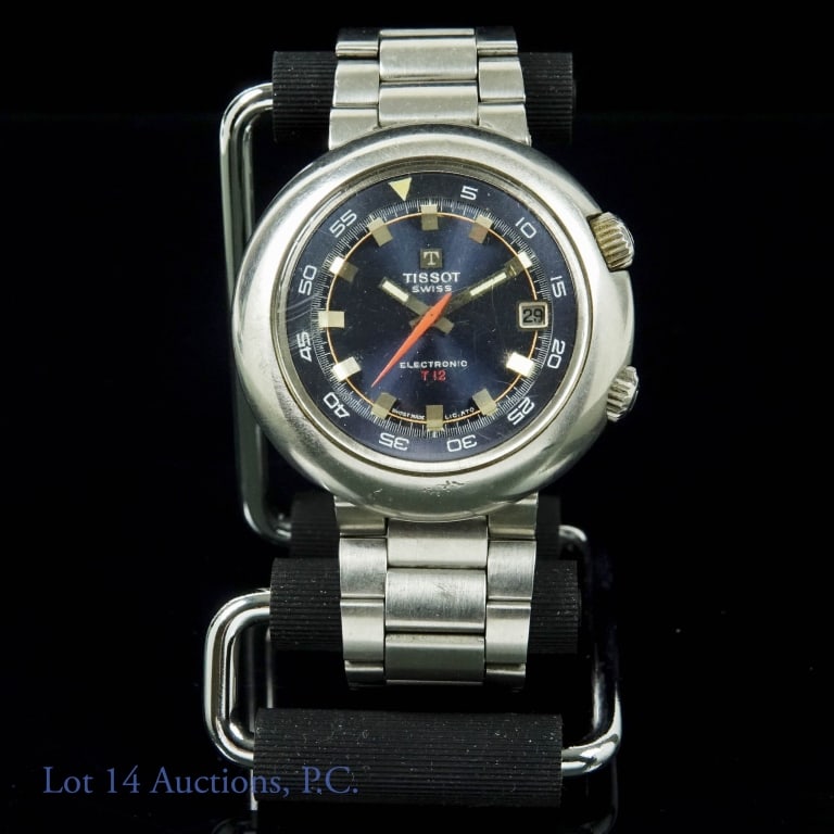 Men's Tissot Electronic T12 Date Wristwatch, 1970s: Men's Tissot T12 Electronic date wristwatch. Blue dial is in good condition. Running (new battery), but untested and not serviced. Inner rotating bezel. Original Tissot metal strap. 44mm (at 3 / 9 o'c