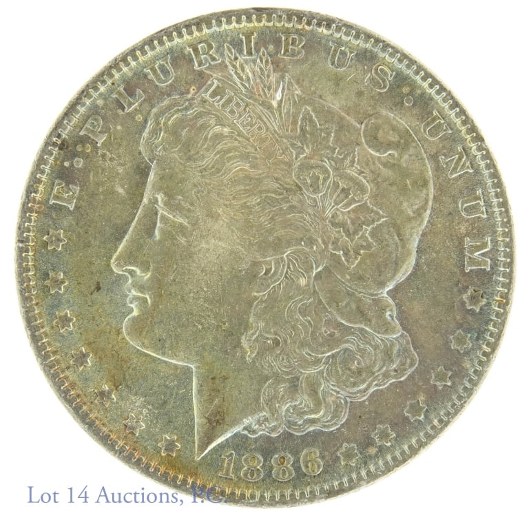 1886 Morgan Silver Dollar (BU? & Toned): 1886 Morgan dollar (Philadelphia Mint). 90% silver (electronically verified in our shop). Per consigner, brilliant uncirculated. Nice obverse (blues and violets) and reverse (golden red-brown). 26.6 g