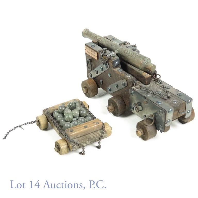 Wood & Brass Cannon Model & Ball Trailer: This lot includes a wooden and brass model of a cannon, measuring 9 3/4" x 3 3/4". Includes wooden and brass trailer with 25 mini metal cannon balls. Trailer has brass plaque on the side that says "Fu