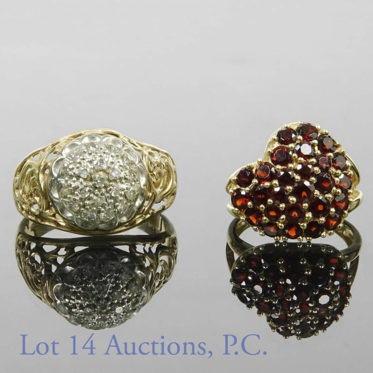 10k Gold Rings (2) Truglo, Diamond, Garnet: Two 10k yellow gold rings. One features a heart made of many red garnet stones (size 5.75), the other is from designer Truglo and is adorned by melee diamonds in the center (size 9). Total weight: 8.9