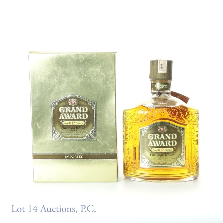 1967 Grand Award Canadian Whisky (12 Yr): 1967 Grand Award blended Canadian whisky. 12 years. 90.4 proof. 750 ml. Neck tag present. Original (rougher condition) box.