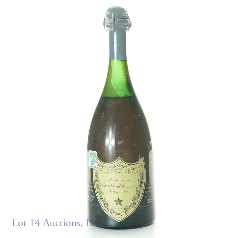 1955 Dom Perignon Champagne: Moet & Chandon Dom Perignon 1955 champagne. 12.5% ABV. 1 pint, 9.5 fluid ounces. Fill is approximately 2" below the bottom of the grey seal. Signs of sedimentation on one side of the bottle. No box. I
