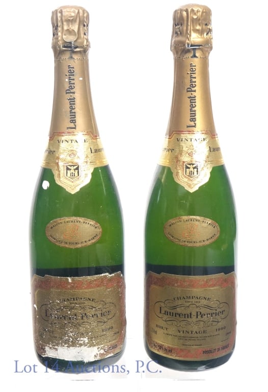 1990 Laurent Perrier Brut Champagne (2): Two bottles of Laurent Perrier brut champagne. 12% ABV. 750 ml. Both bottles are dirty, but one is substantially dirtier with partially obliterated front label.