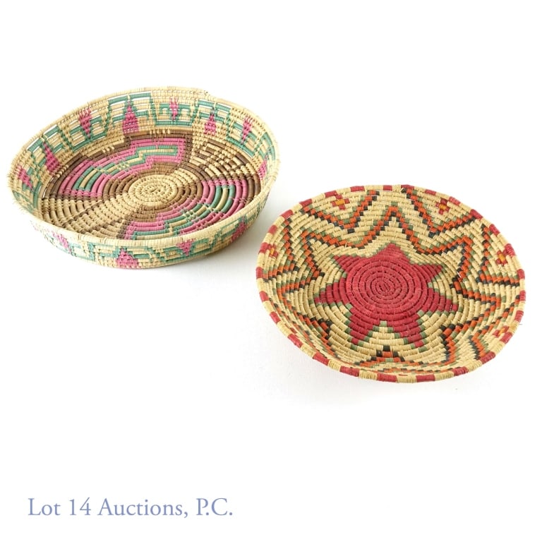 Native American Basket Bowls (2): 2 Native American basket bowls. Footed bowl with red star in the middle. 10.75" diameter. Tray-style basket with darker brown, purple and teal colors. 13.25" diameter. 2.5" deep.