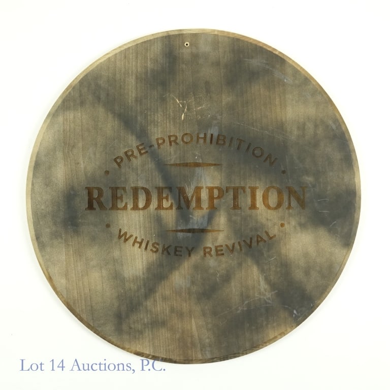 Redemption Whiskey Barrelhead Wall Plaque: Wall plaque made from a barrel head. Reads: Pre-Prohibition Redemption Whiskey Revival. 21-1/8" diameter. Mounting hole present at top. Back side looks very clean, so we are not claiming that this is 