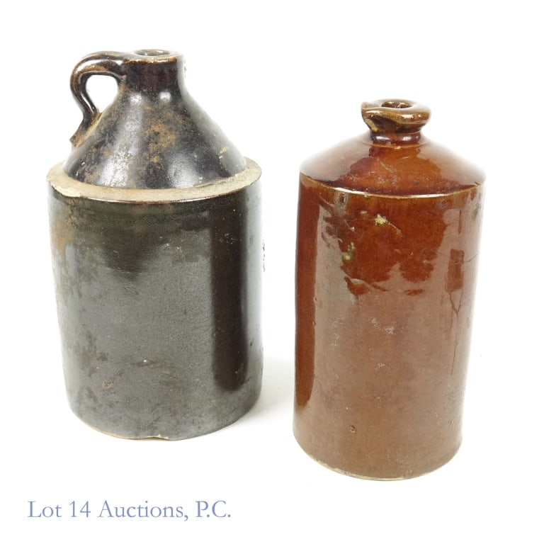 Stoneware Jars (2): Two stoneware jars. One has a finger handle and is mostly black in color. 9.25" tall. Approximately 5.25" diameter. 3.9 pounds (1.77 kg). Some chips throughout. ****** The second stoneware jar has a s
