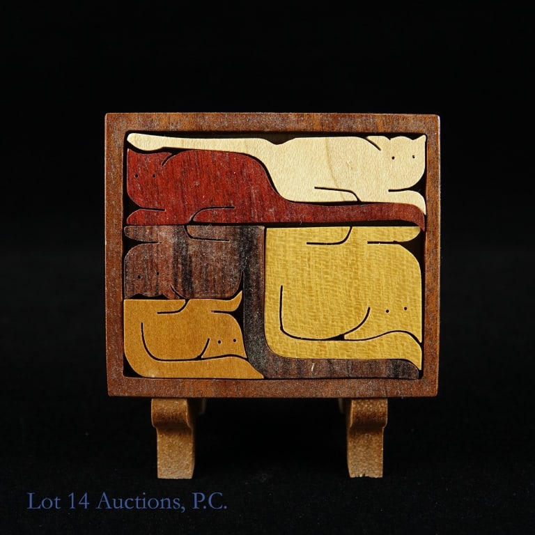 Jerry Krider Miniature Wooden Cat Puzzle: Miniature wooden puzzles consisting of pieces shaped like cats by Jerry Krider. 2.5" x 2-1/8". Includes wooden easel.