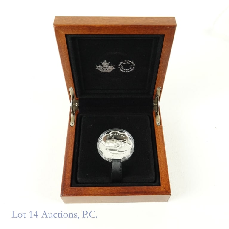 RCM 2016 Silver $20 Masters of the Sea - Orca Coin: Orca Royal Canadian Mint 2016 silver proof scallop shaped $20 "masters of the sea - the orca" coin in OGP which includes a maple wooden display box. Metal is 99.99% silver and weighs 26.51 grams. COA