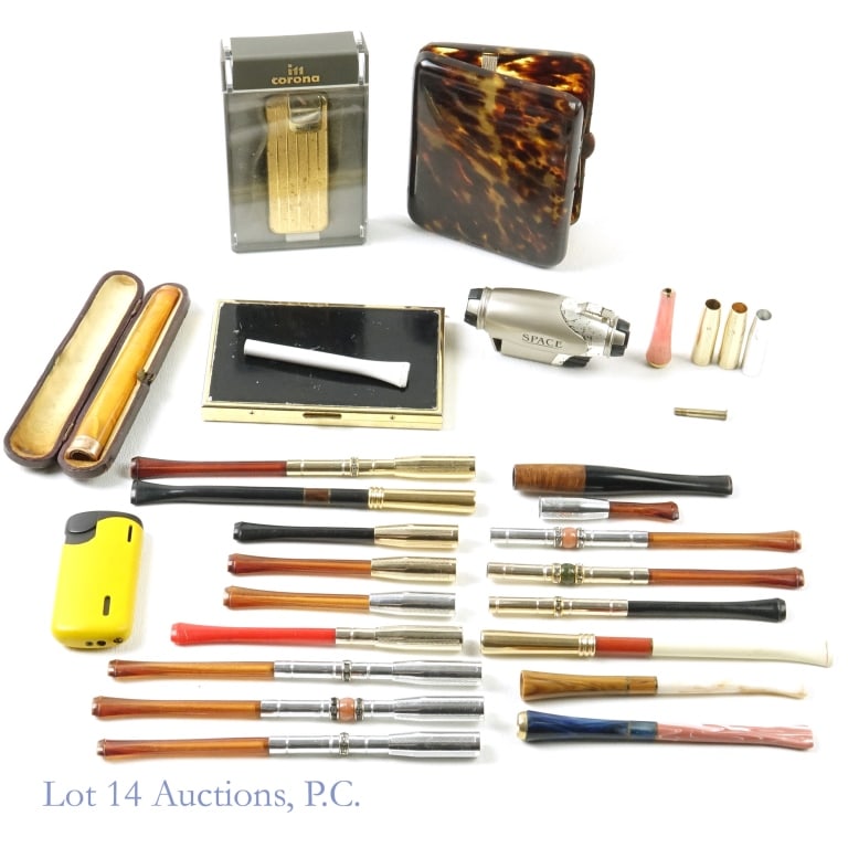 9k Y. Gold Band, Dunhill Cigarette Holders & More: Cigarette holders, including one marked .375 on the gold band. Dunhill white spot wood cigarette holder. Also cigarette cases, one marked Lucienne, the other has a small chip / crack at the catch. Jap