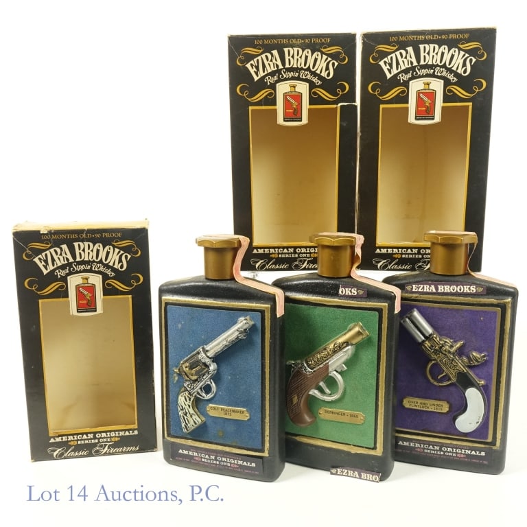 Ezra Brooks Classic Firearms Bourbon Decanters (3): 1-Ezra Brooks 100 Month Over and Under Flintlock 1815 Bourbon Decanter, 90 Proof, 4/5 Quart, American Originals Series One. Large crack in front adhesive wrap on front of bottle. Slight wear on tax st