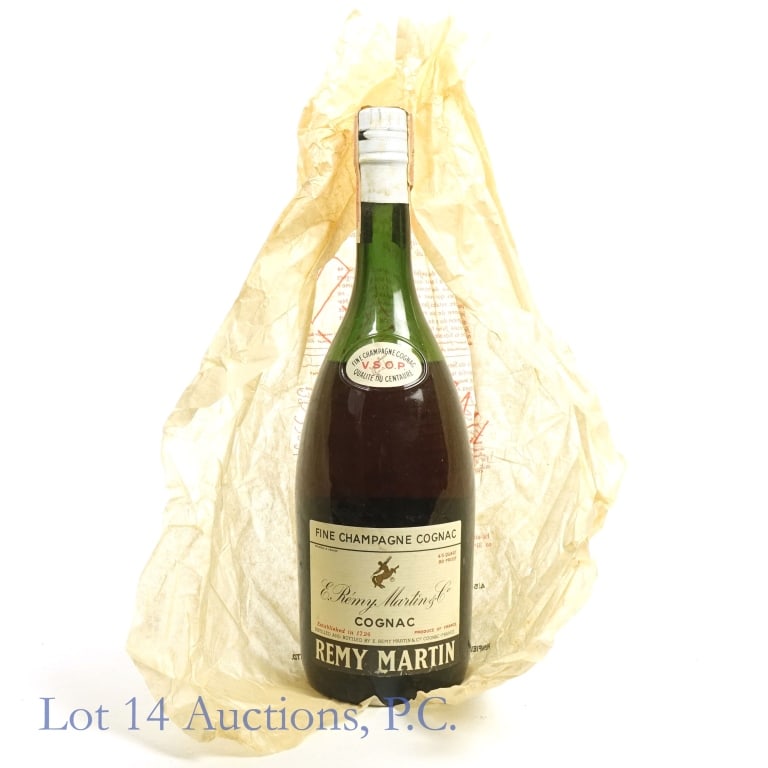 60s/70s Remy Martin VSOP Fine Champagne Cognac: Remy Martin VSOP Fine Champagne Cognac, 80 Proof, 4/5 Quart. 1960s/1970s bottling. Tax strip stained with small tears but remains intact and in fair condition. Foil seal underneath strip also stained.