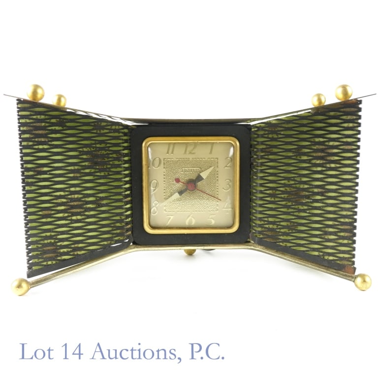 United Clock Corp Model 340 MCM Bowtie Clock: United Clock Corporation electric mid-century modern bowtie table or shelf clock. Model No. 340. Brass metal. Luminous hands. Clock operates when plugged in. Left side lights up when lights are turned