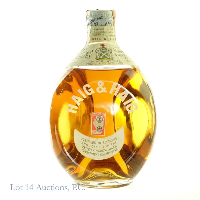 40s/60 Haig & Haig Blended Scotch: Haig & Haig Blended Scotch, 86.8 Proof, 4/5 Quart, 1940s-1960 bottling. Tax strip very worn with slight surface tears, strip intact overall and in fair condition considering its age.